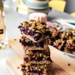 These browned butter blueberry oatmeal crumble bars are bursting with all the goodness of sweet summertime blueberries, nutty browned butter, and heart healthy oats. Make a batch today! #brownedbutter #brownbutter #recipes #dessert #oatbars #blueberrybars #blueberries #oatmeal