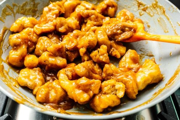 saucing orange chicken | www.iamafoodblog.com